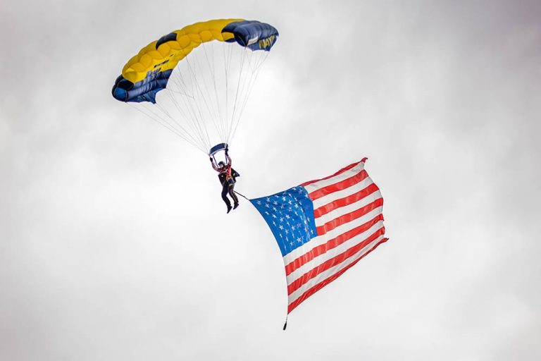 Photo of Leap Frog participant with parachute and American flag