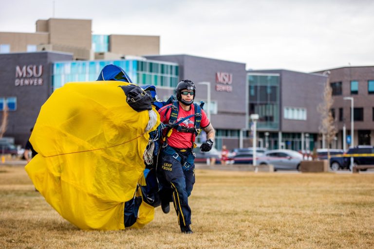 A U.S. Navy Leap Frogs Parachute Team member lands on the Auraria Campus