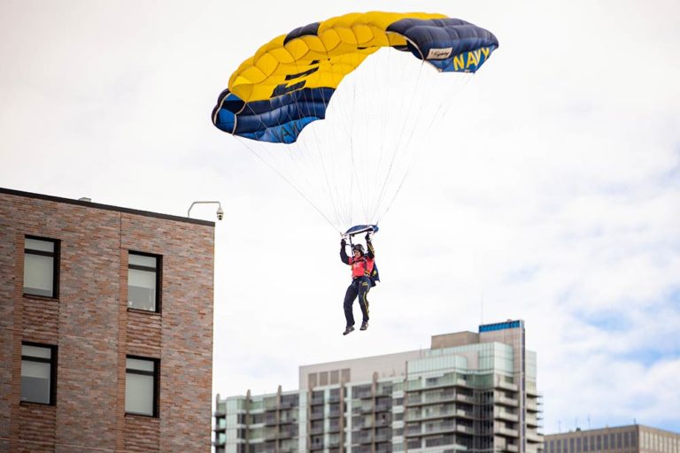 Leap Frog participant hovers in the sky with parachute