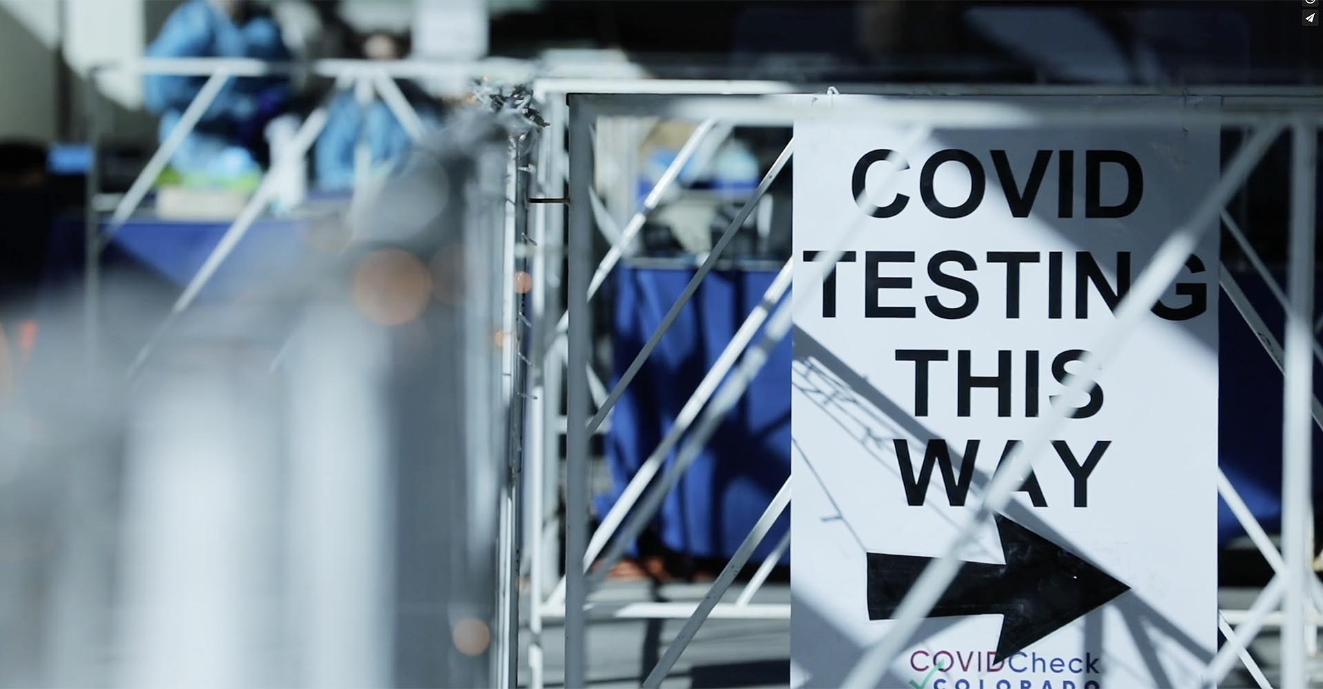 Sign with the text "Covid Testing This Way"