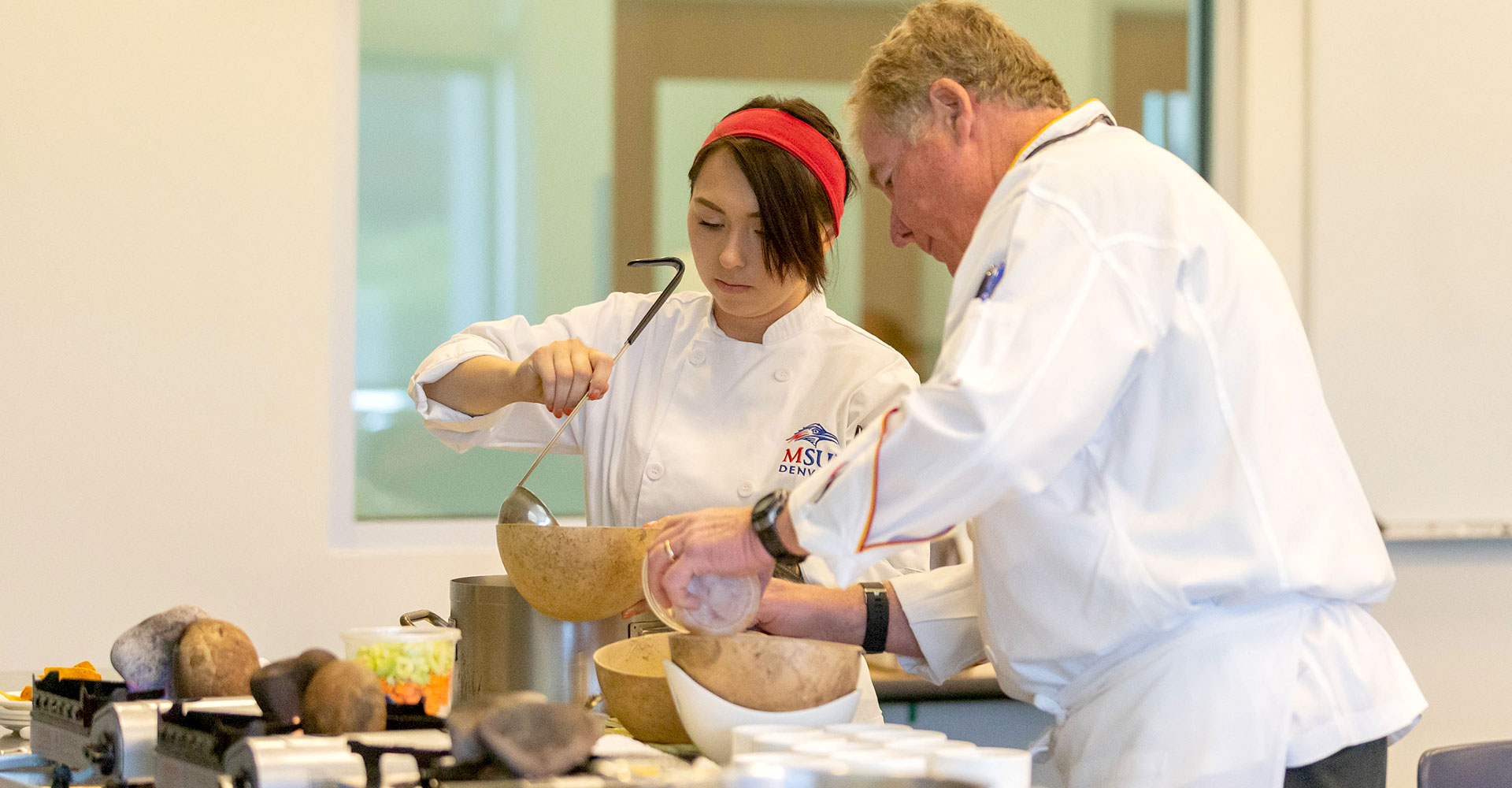 Photo of two chefs cooking at the School of Hospitality