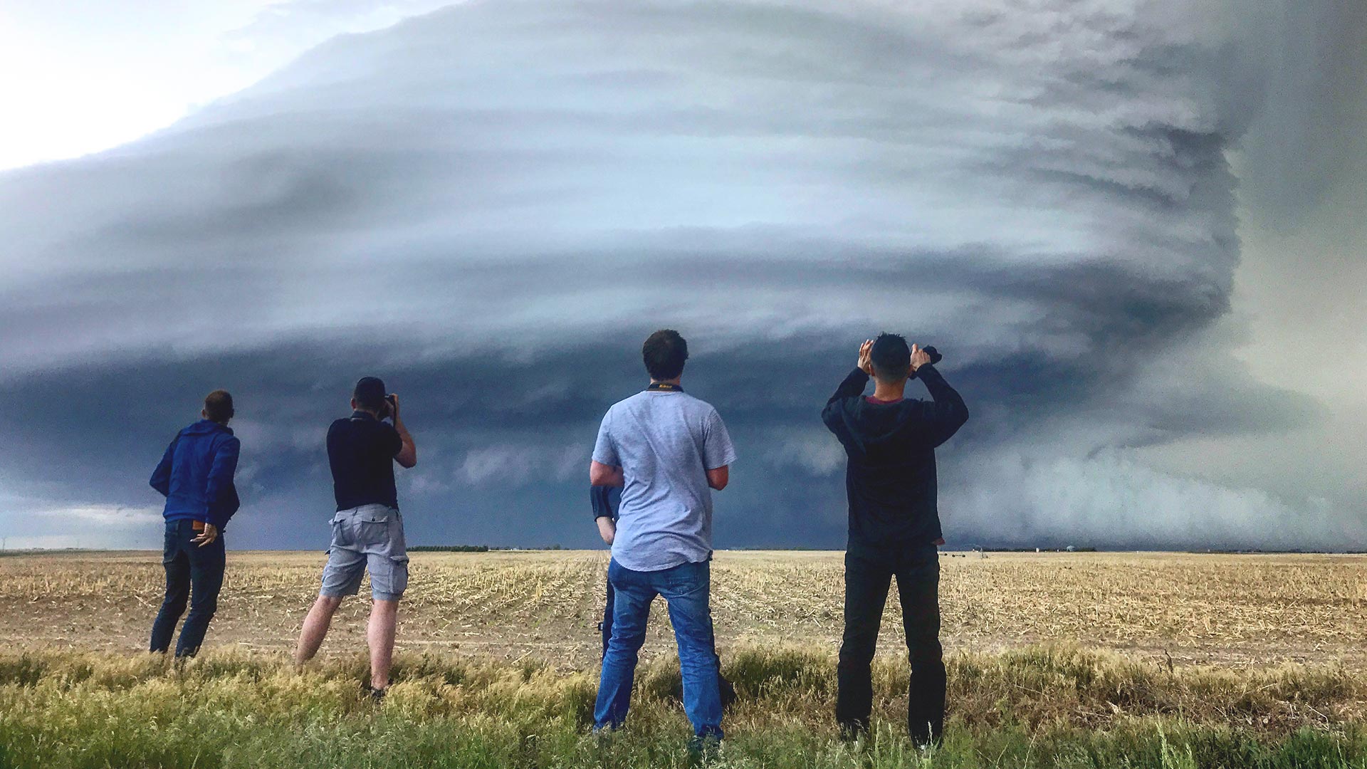 Photo of three students watching a tornado evolve in a MSU Denver class