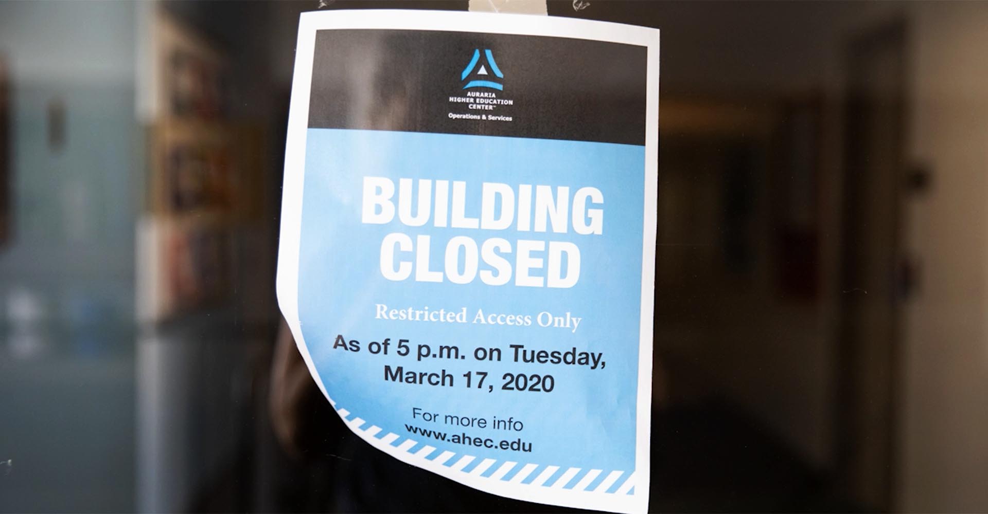 Photo of sign with the text "Building Closed / Restricted Access Only / As of 5 pm on Tuesday, March 17, 2020 / For more info www.ahec.edu"