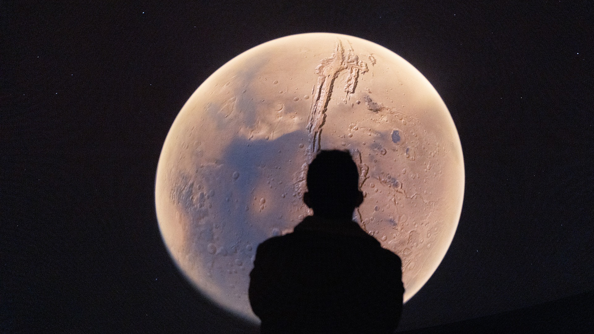 Silhouette against a moon at the Denver Museum of Nature and Science's Planetarium