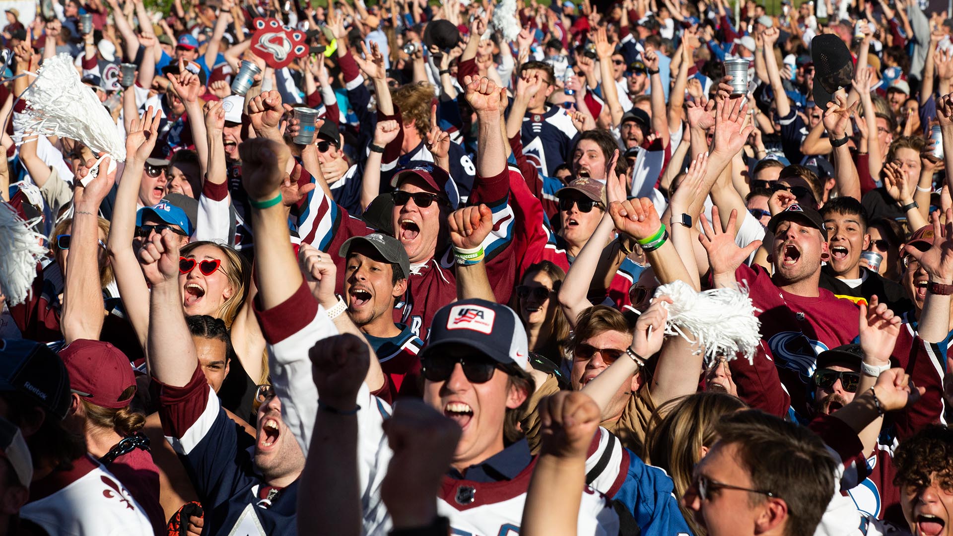 Spectators cheer at the Auraria Campus watch party after the Colorado Avalanche scores the first goal of Game 1