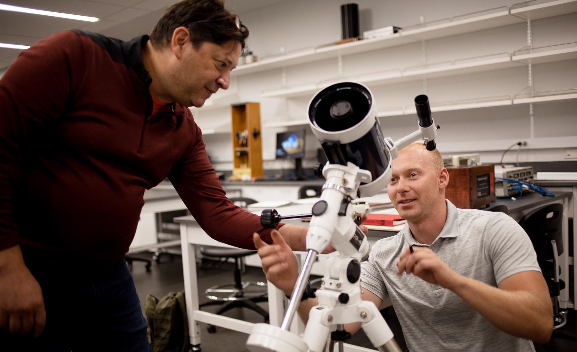 Professor Grant Denn, left, and student Cody Ward and in the Physics Laboratory with the Celestron Omni XLT 127 Telescope