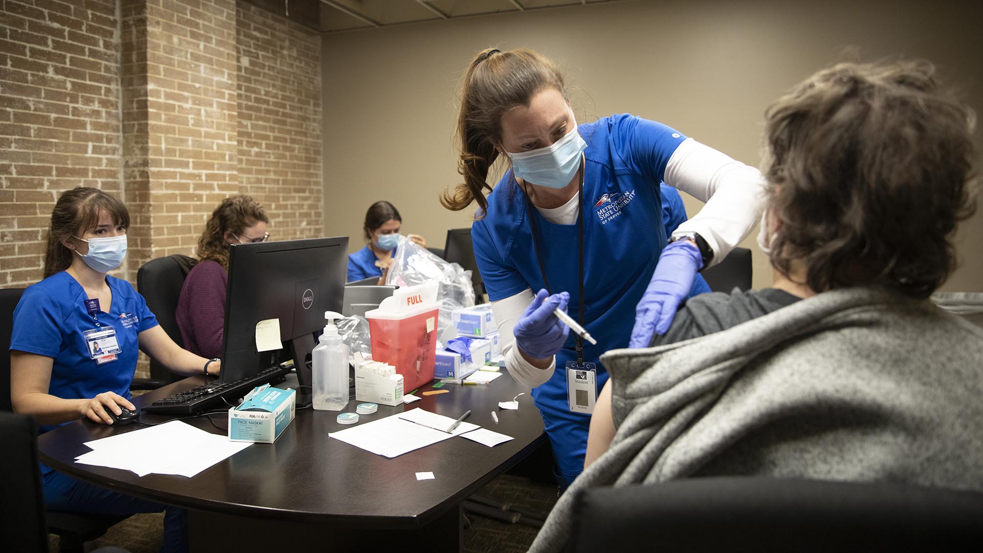 MSU Denver nursing students give Covid vaccinations as part of their clinical rotation at the Colorado Coalition for the Homeless in Denver.