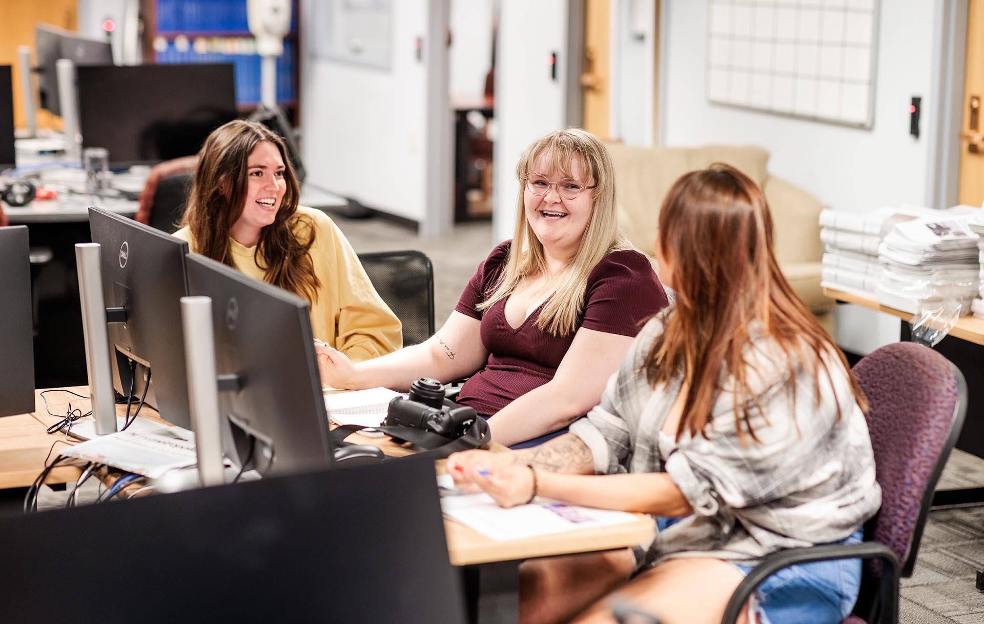 MSU Denver journalism students, Reanna Medina, features editor, left, Sara Martin, editor-in-chief, center, and Tiffani Hernandez, managing editor, work in the Met Media newsroom in preparation for the next issue of the student run newspaper, The Metropolitan.