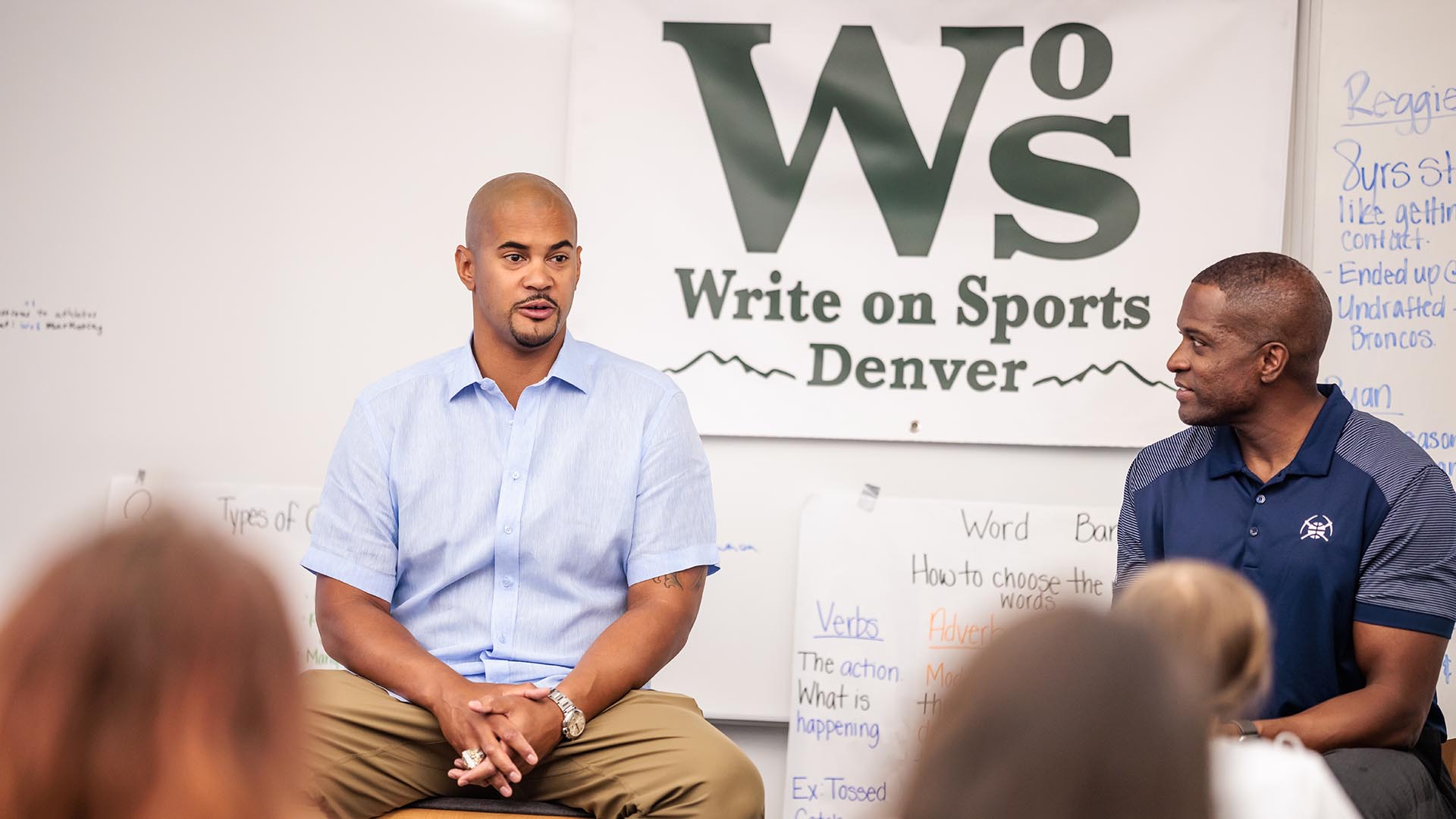 Former Bronco Ryan Harris (left) and Nuggets TV announcer Chris Dempsey speak to the class