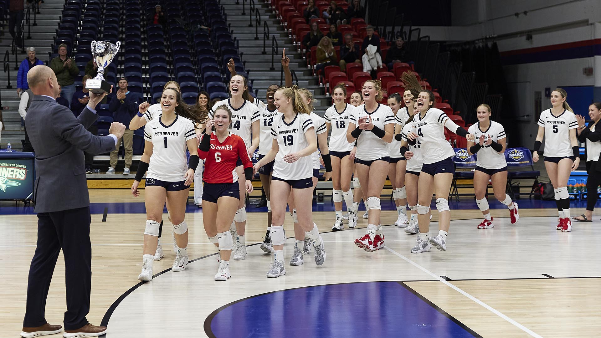 MSU Denver's women’s volleyball team accepts their trophy