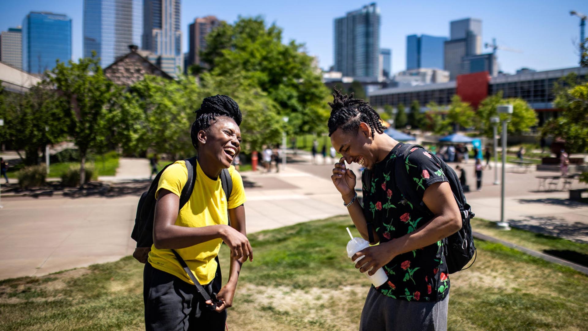MSU Denver students Mussu Dolly, left, and Elijah Sanditer, laugh together on campus
