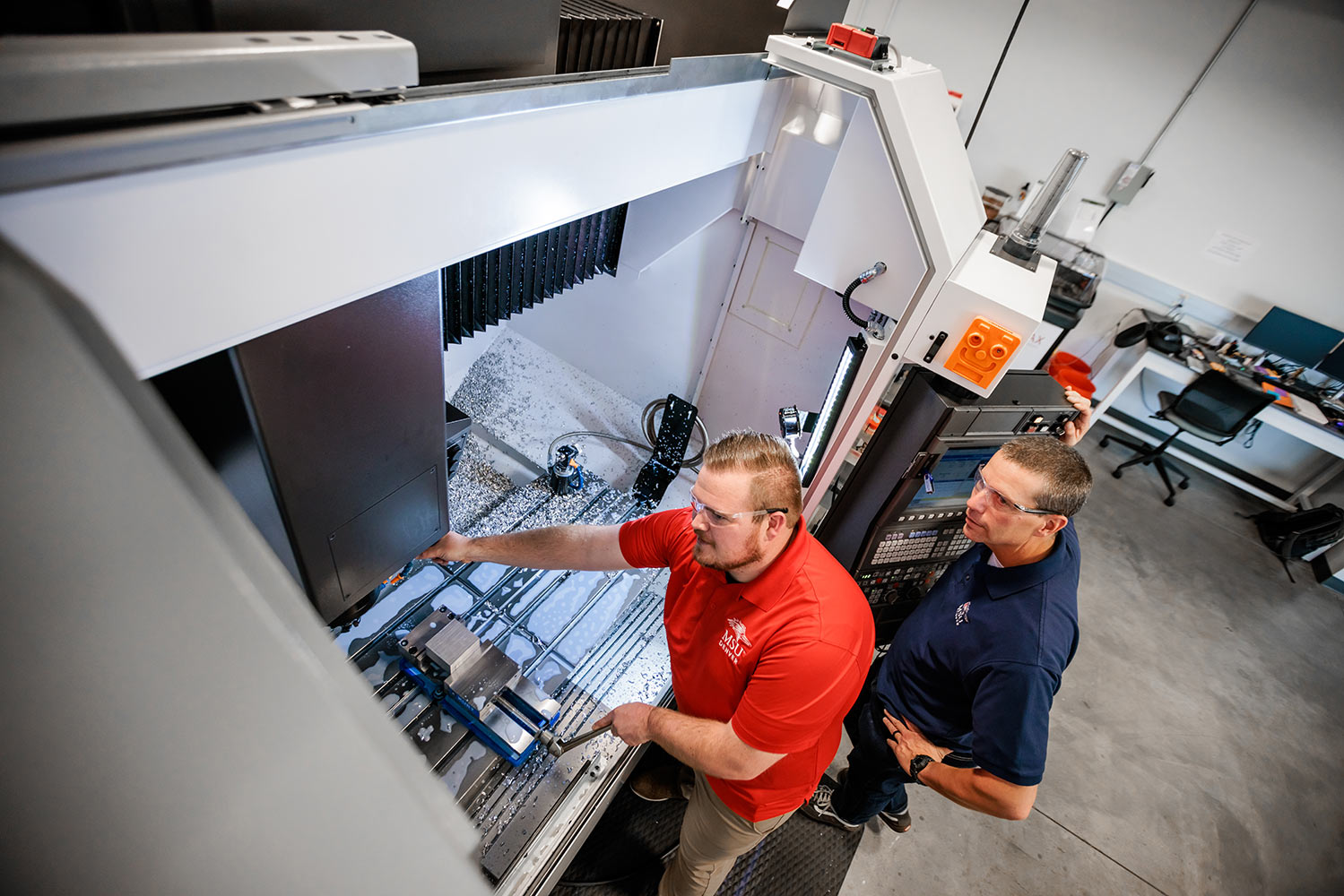 Steven Finch and Stephen Morgan work in an MSU Denver advanced manufacturing lab.