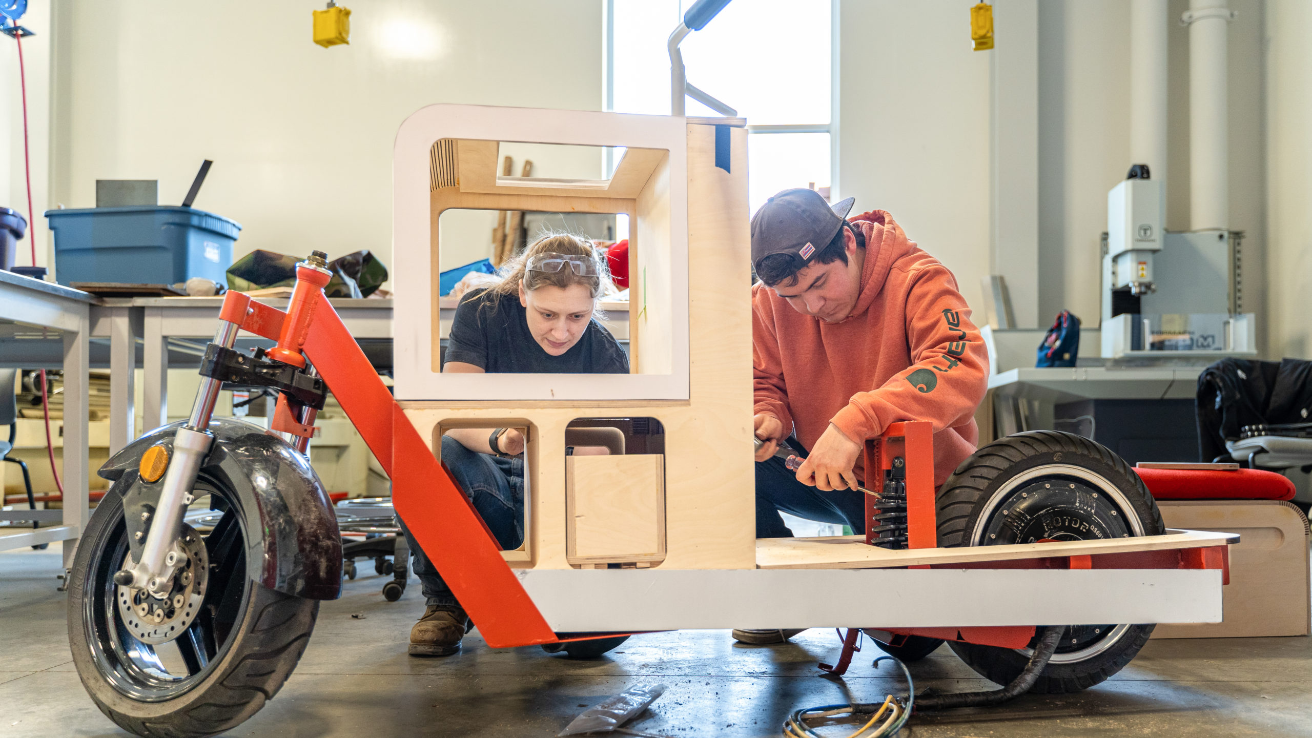 MSU Denver Industrial Design students Lydia Snyder and Andrew Baxte work on creating a functional electric cargo bike.