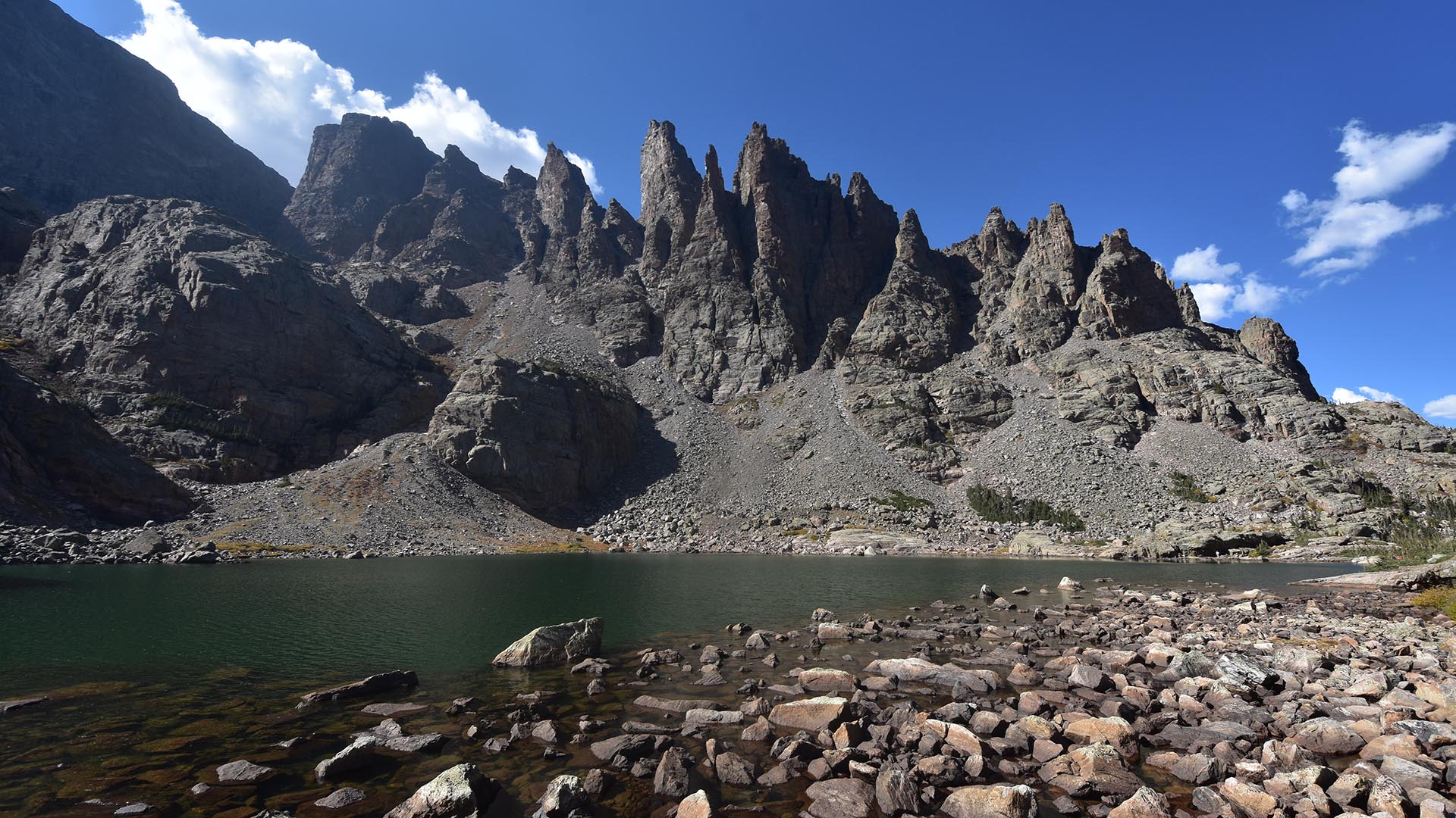 A photo of cliffs and a pound at Sky Pond in scenic Rocky Mountain National Park