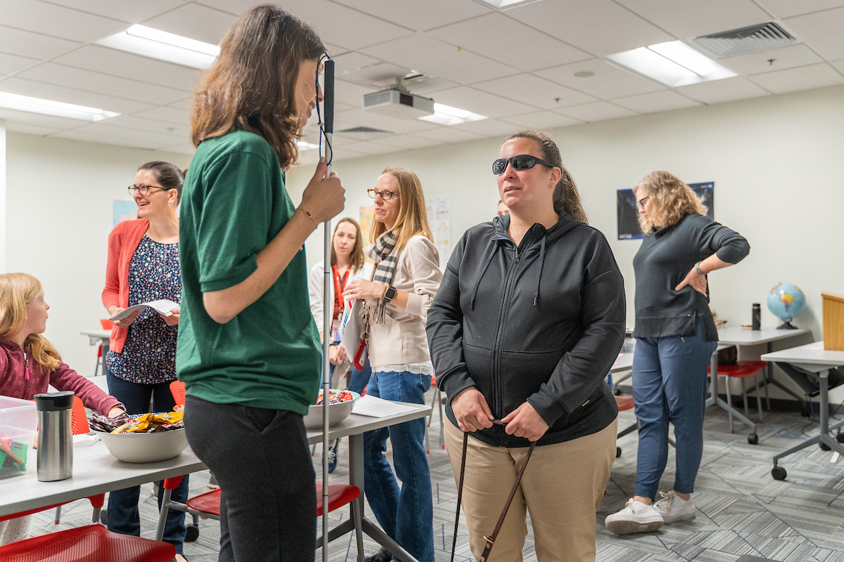 MSU Denver senior Charis Glatthar works with participants at the STEM event for people who are blind and low-vision.
