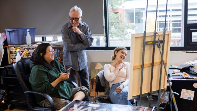 MSU Denver art professor Carlos Fresquez laughs with students Micah Ramirez, left, and Morgan DeVillier