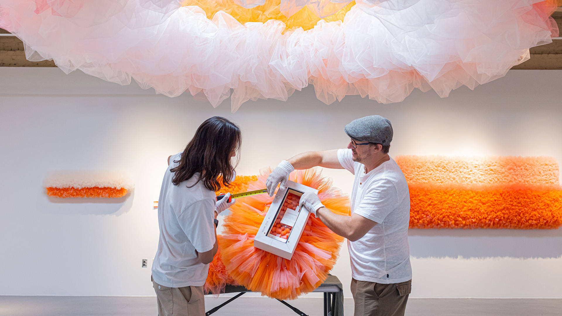 Andrew Cline, right, and Maxwell Kwan are installing work of Ana María Hernando for an exhibition Colorado Women to Watch.