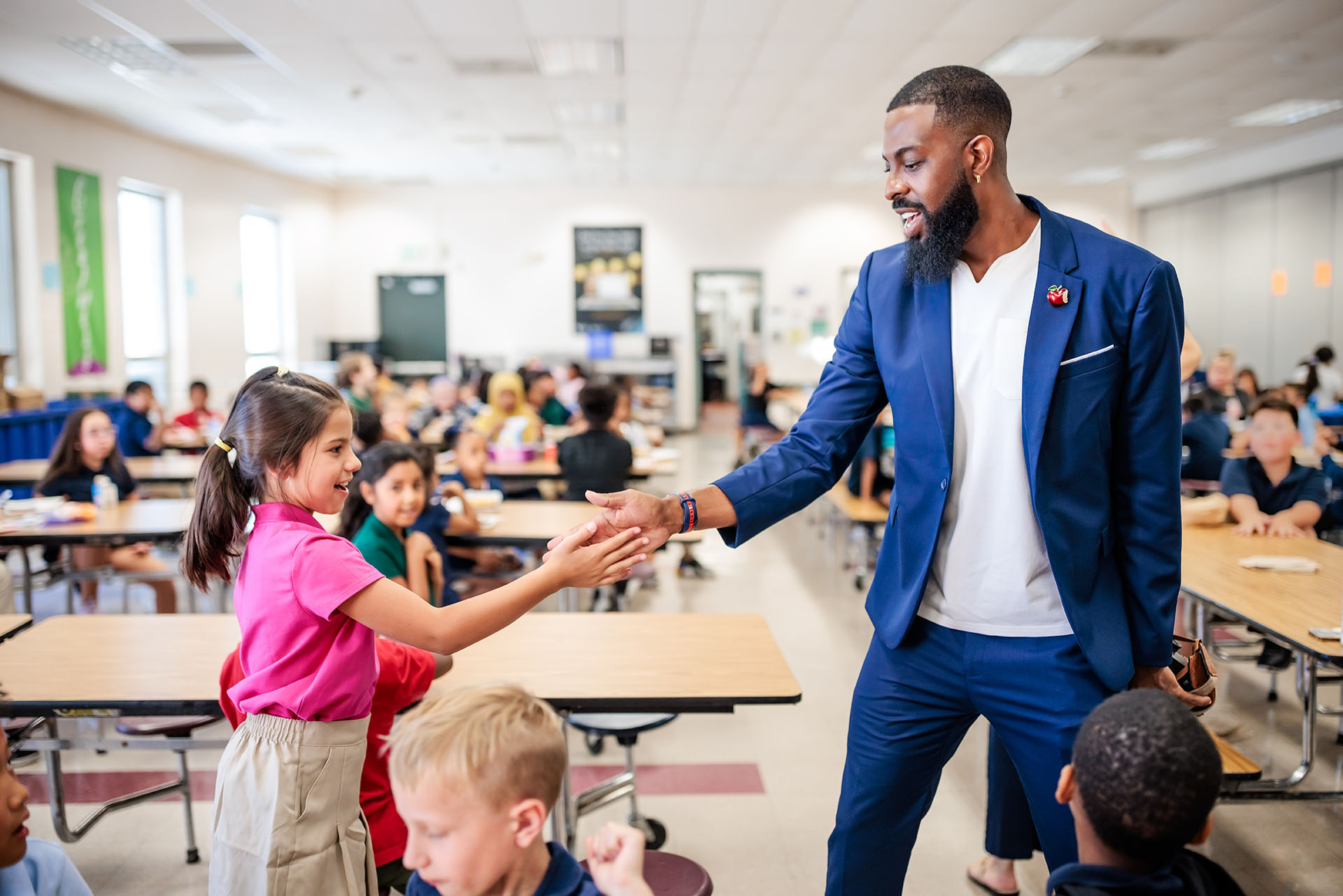 MSU Denver’s Director and Associate Professor in the esteemed School of Education, Rashad Anderson, does a handshake with a student at Green Valley Elementary School on Sept. 25, 2023.