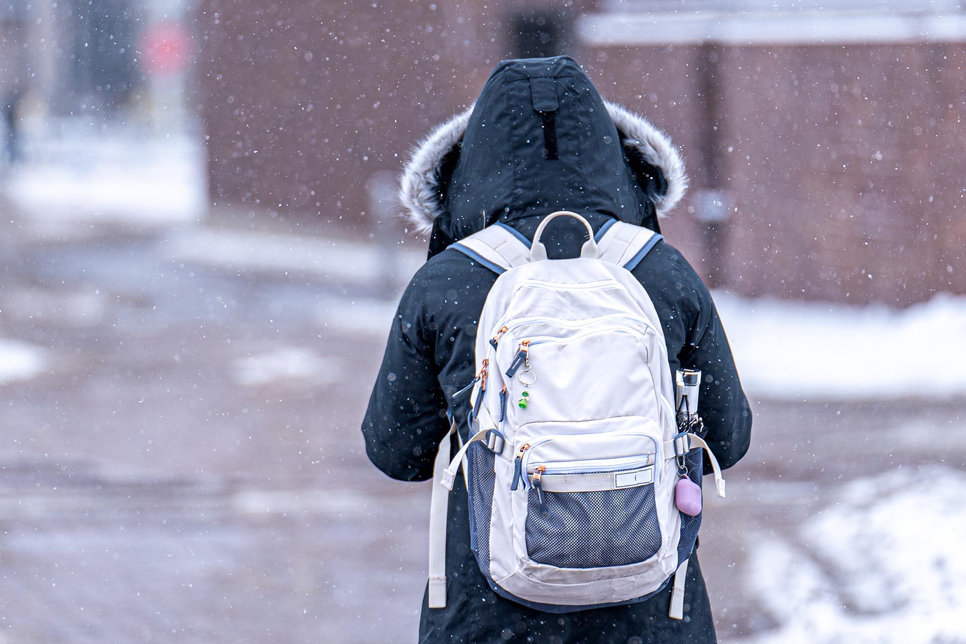 Student on Auraria Campus walks in the snow in February, 2023