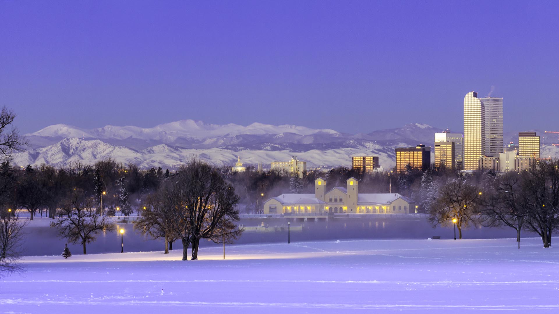 Panorama of Denver Colorado skyline at sunrise, day after winter snow storm from City Park and Denver Museum of Science and Nature