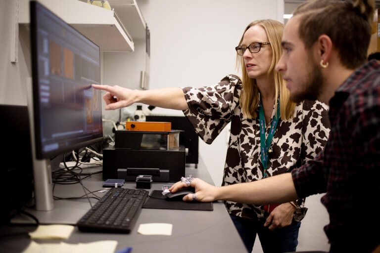 Dr. Azure Avery has her student, Sam DeChima, run a scan on a film of single walled carbon nanotubes on an atomic force microscope