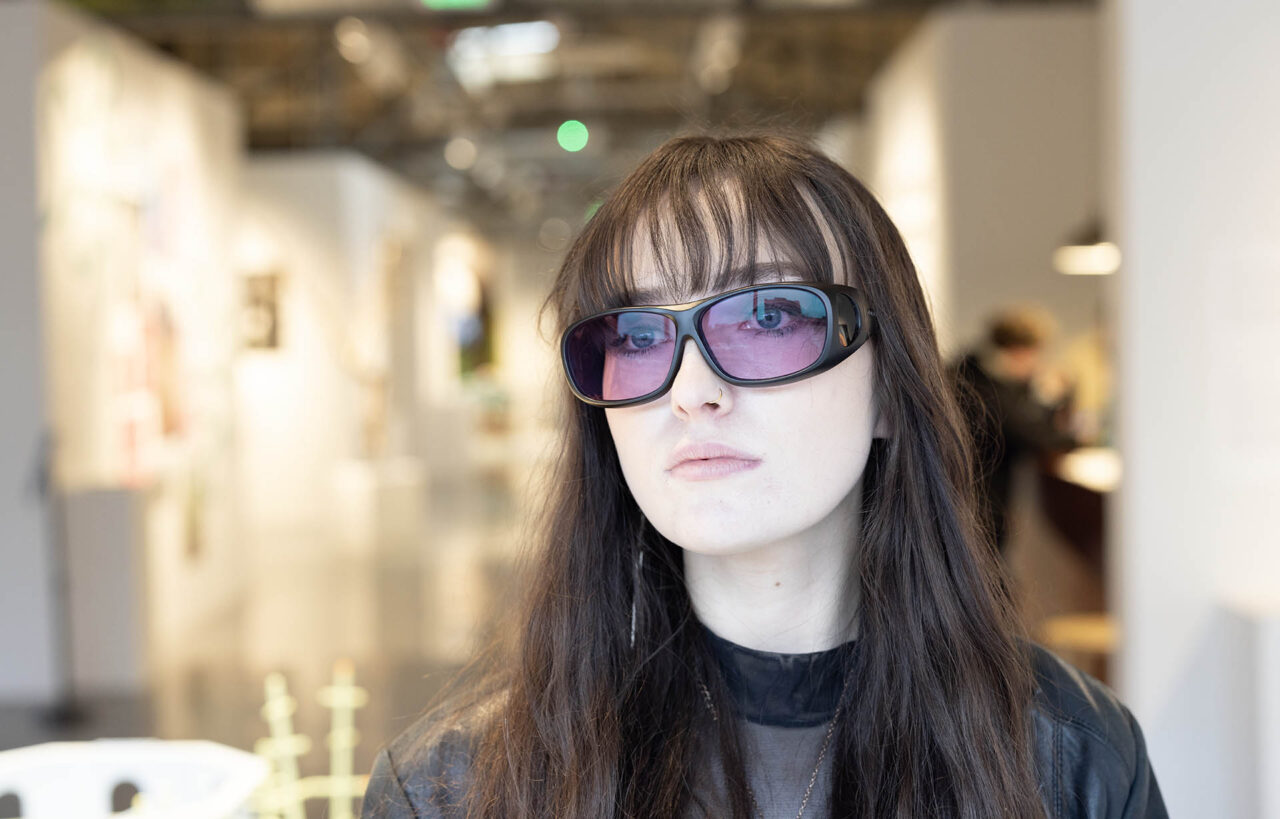 CVA gallery assistant Bridget Ebert tries on a pair of Enchroma glasses.