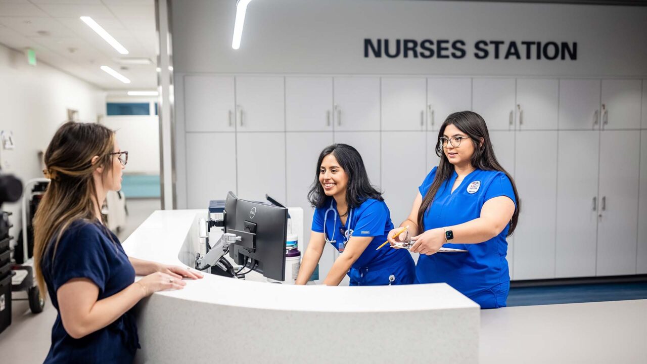 MSU Denver nursing students Jimena Malta, left, and Marisa Schreiner, talk with Nursing Simulation & Skills Lab Assistant Jessica Parks