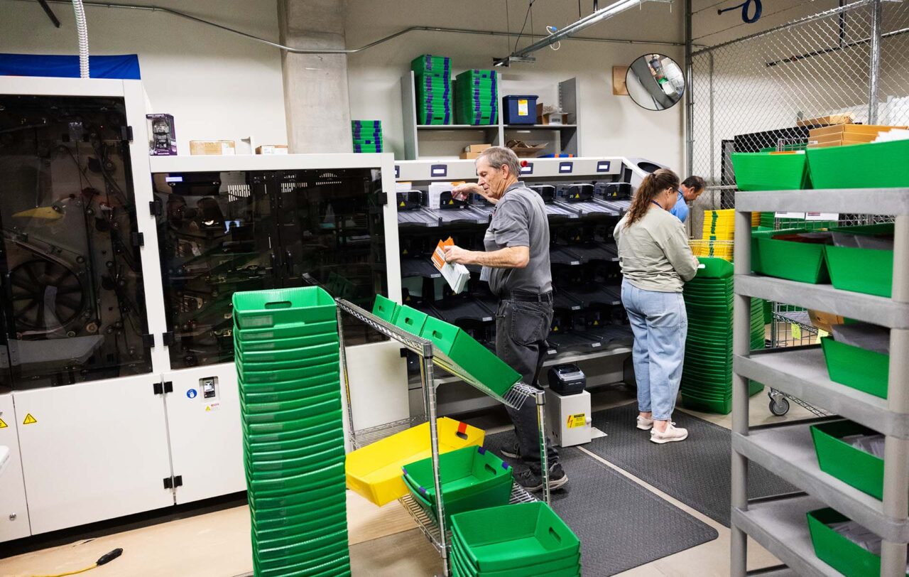 A bipartisan team collect ballots after going through the state-of-the-art ballot sorter