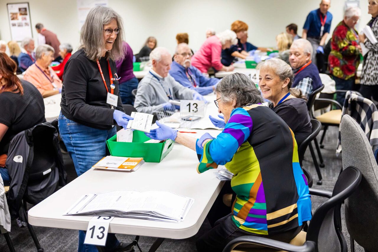 Bipartisan teams of judges remove ballots from the envelopes, separating the vote from the voter and preserving the anonymity of a vote in the casting room at the election center.