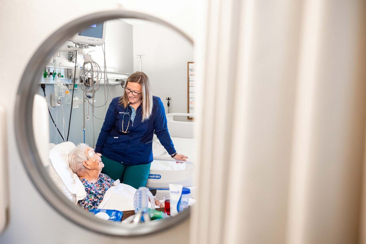 MSU Denver alumna Jessie Cochran visits with patient Frances Boerner.