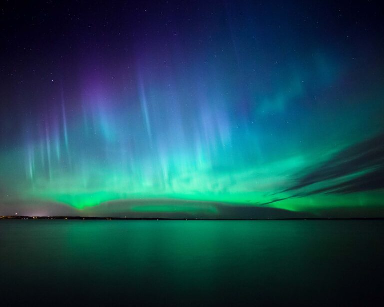 Beautiful northern lights aurora borealis over lake in finland