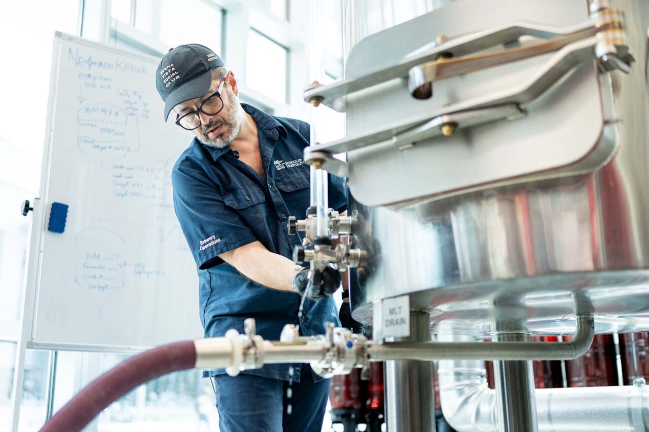 Lecturer and program coordinator Bernardo Alatorre demonstrates how to gather and test a sample to brewing students.
