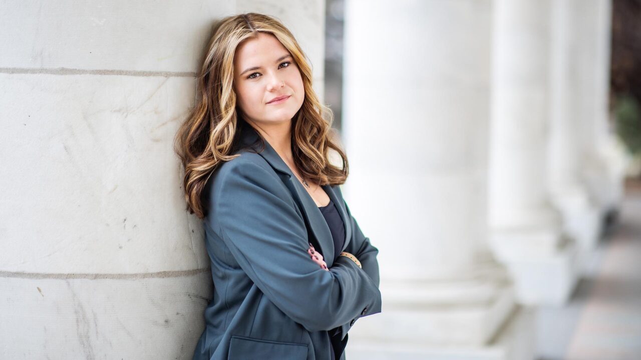 Hailey Glass stands in front of white columns