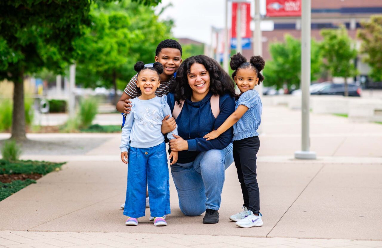 Mariyah Younger poses with her three children Celeste Younger, 4, Nolan Kersey, 9, and Jade Younger, 3, outside of the Jordan Student Success Building on campus