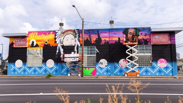 MSU Denver alumni artists Ramon Trujillo and Adrian Raya paint the Tribute to the Westside Mural on the Kalamath building.