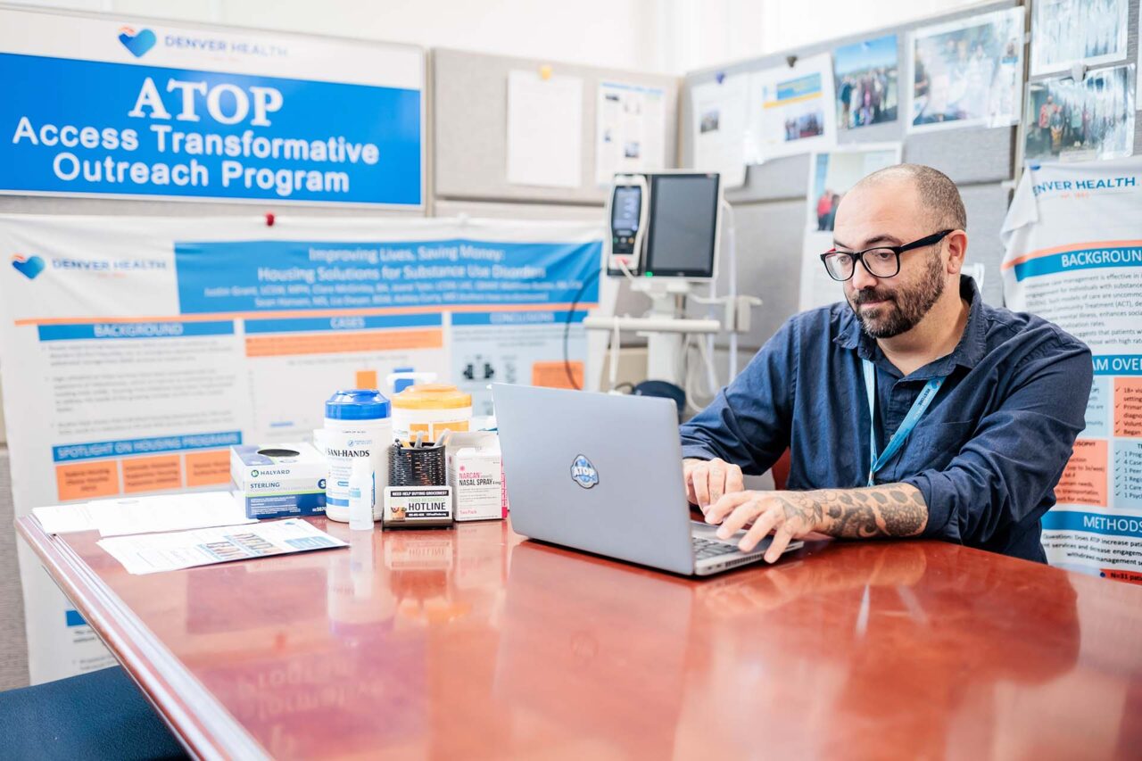 Matthew Bustos works at his internship at the Denver Health campus.
