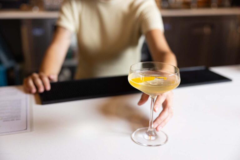 An Itzatini, a cocktail made from gin, chamomile simple spirit, grapefruit liqueur and a citrus twist.