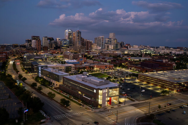 MSU Denver at night against the Denver skyline