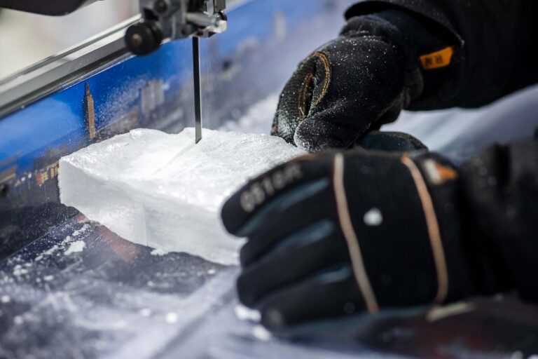 Richard Nunn uses a vertical bandsaw to cut a sample of ice.