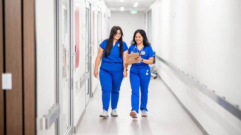 MSU Denver nursing students Marisa Schreiner, left, and Jimena Malta walk in the hallway of the Gina and Frank Day Health Institute