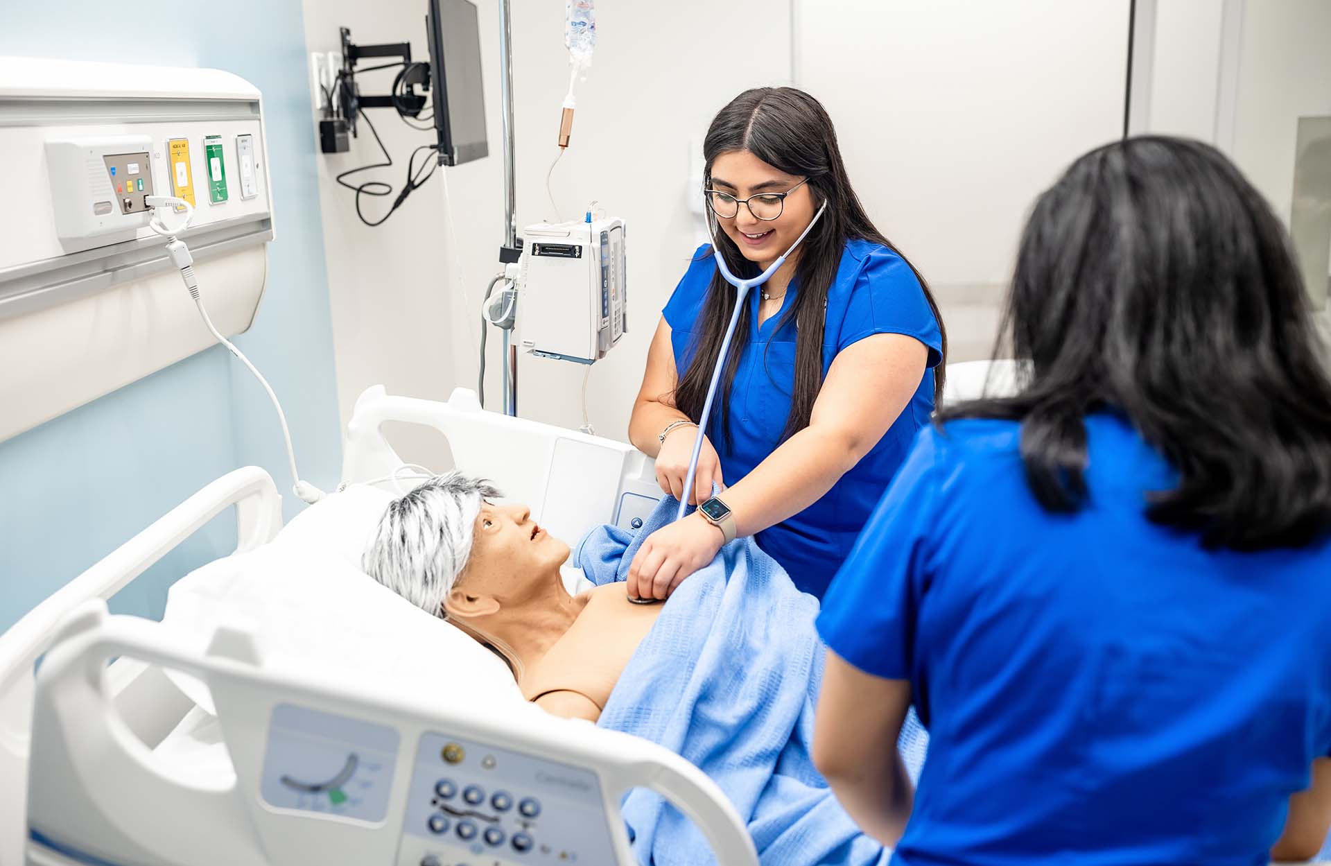MSU Denver nursing students Marisa Schreiner, listens to lung sounds with a fellow studen at the Simulation and Skills Laboratory.