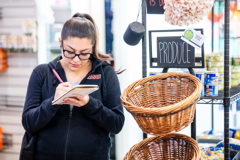 MSU Denver MBA graduate student Elisa Padilla takes notes during a tour at Rowdyís Corner.
