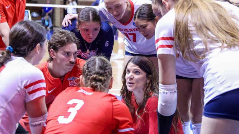 Head coach Jenny Glenn of the MSU Denver Roadrunners leads her team in a huddle during the game