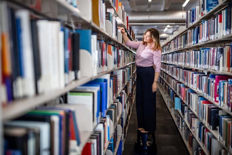 Mallory Reiswig browses for books in the Auraria Library.