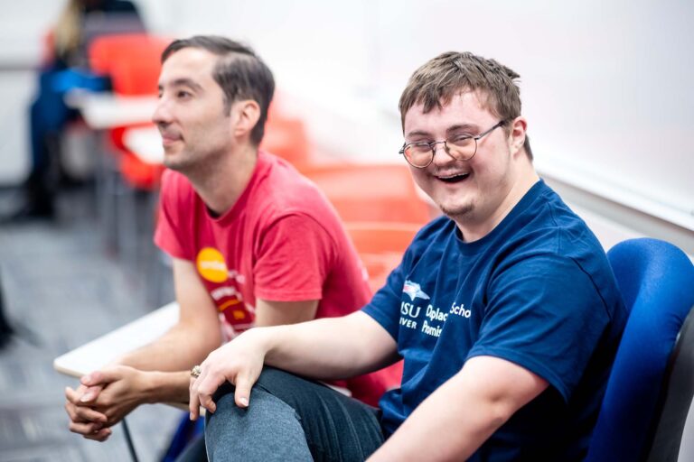 MSU Denver students Frankie Newhart, left, and Daniel Barbier with the Inclusive Support Services program, sit at their desks during an Academic Success class.