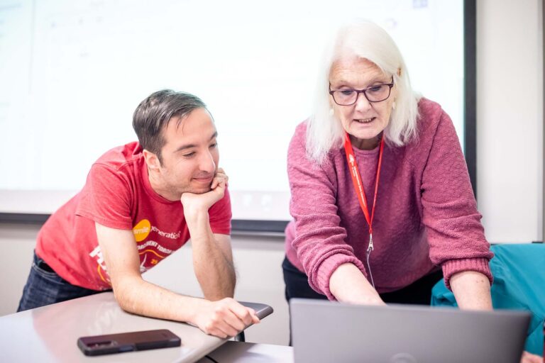 Interim Director Cathi Allen works with student Frankie Newhart in class