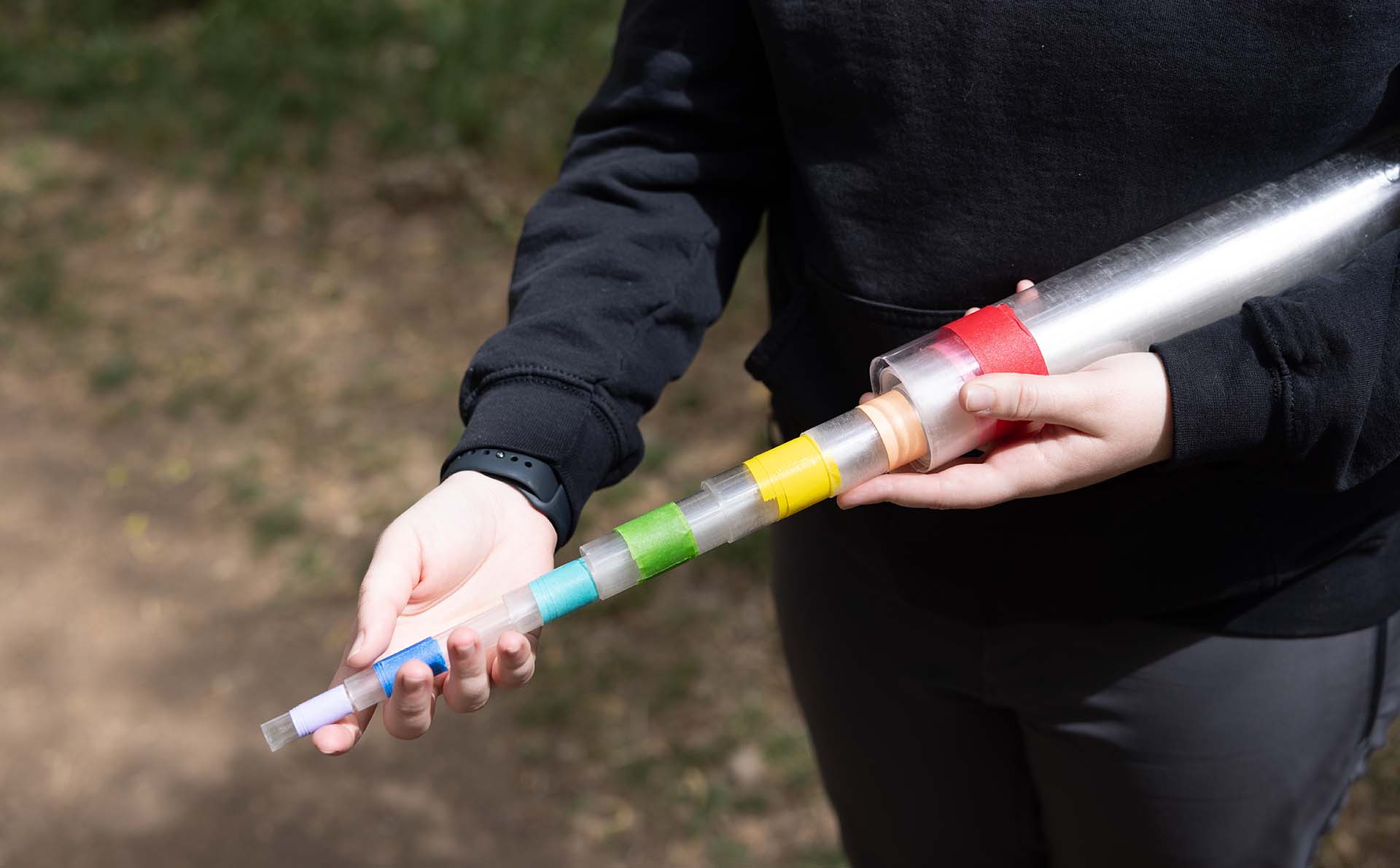 Claire Tiemann shows the tube they use to help with conducting research once a snake is found.