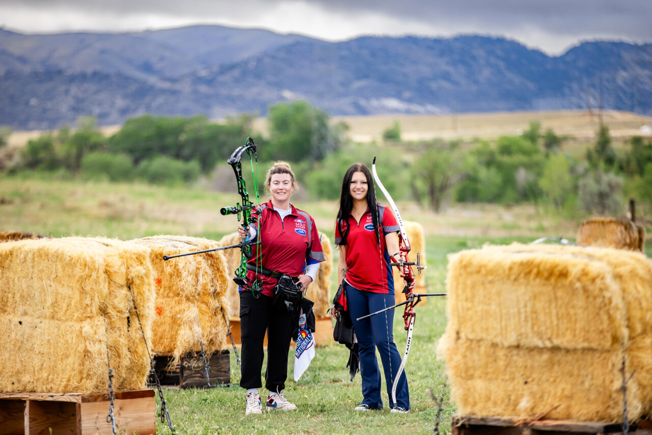 Trinity Weiss, president of the Metropolitan State University of Denver Archery Club and teammate Sierra Nation pose for a photo at Bear Creek Lake Park.