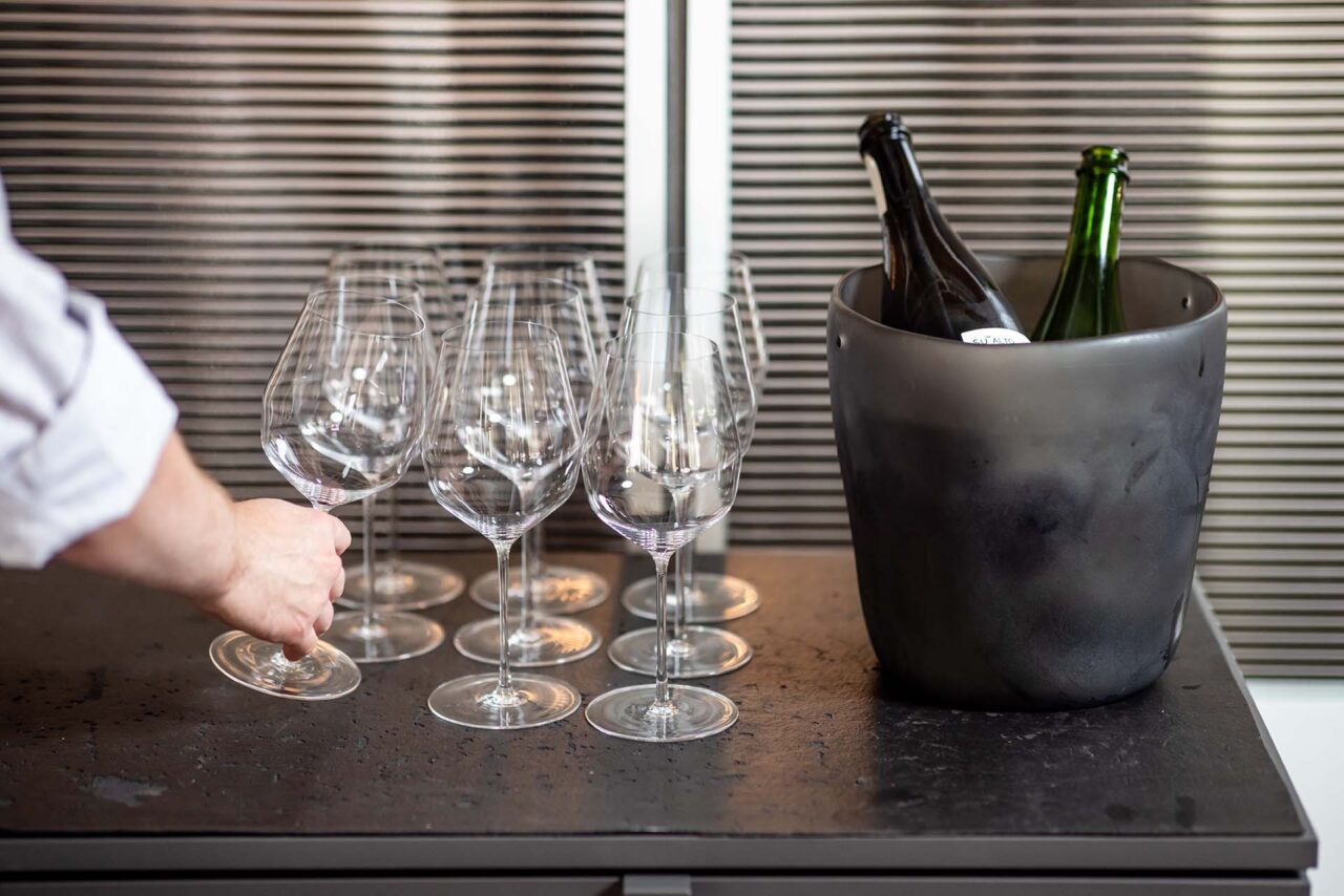 Nicolas Escobedo picks up a wine glass at Brutø.
