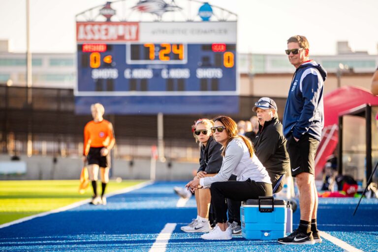 MSU Denver head women's soccer coach Katie Hooker and volunteer assistant coach Jeff Hooker on the sidelines during a match